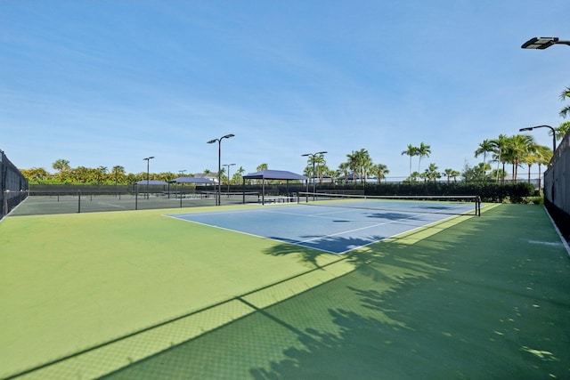 view of tennis court featuring fence