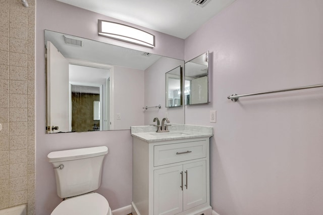 full bathroom featuring toilet, vanity, baseboards, and a shower