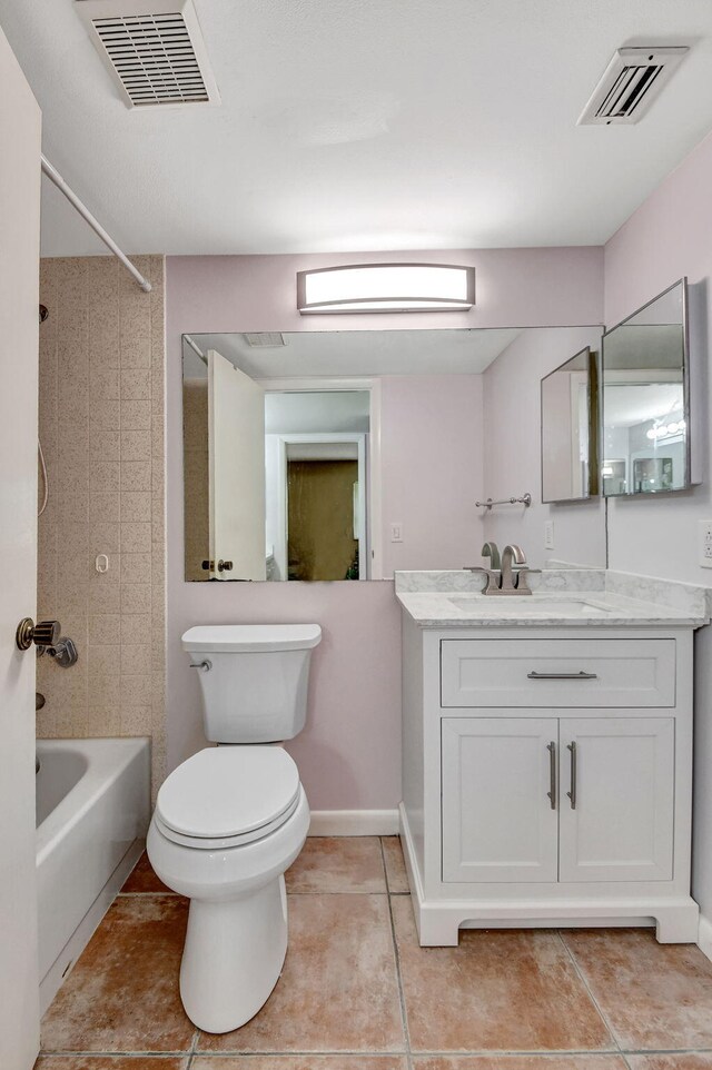 bathroom featuring tile patterned floors, tub / shower combination, vanity, toilet, and baseboards