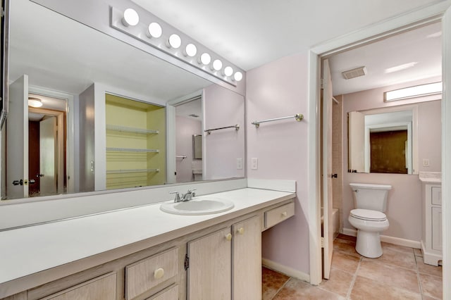 full bath featuring vanity, tile patterned flooring, toilet, and baseboards