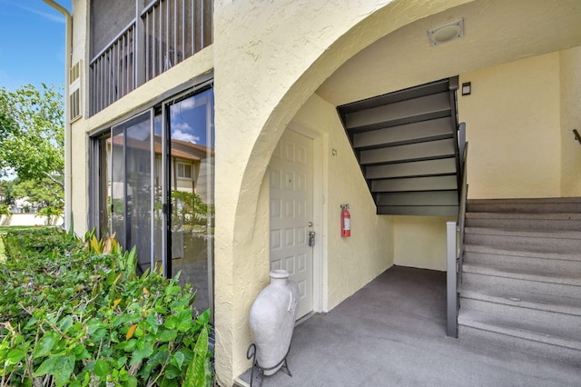 property entrance featuring stucco siding