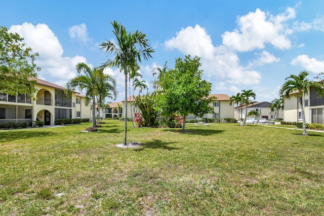 view of green lawn featuring a residential view