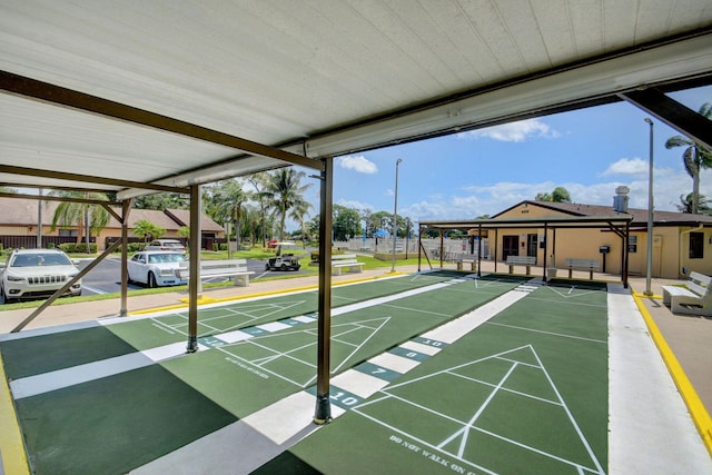 surrounding community featuring shuffleboard and fence