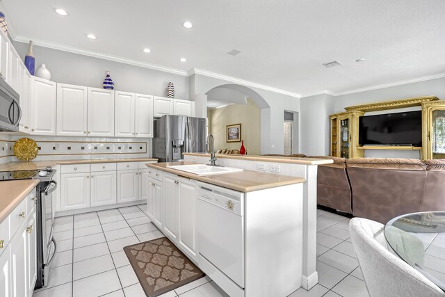 1741 Annandale Cir, Royal Palm Beach, FL 33411 - kitchen with stainless steel appliances, open floor plan, a sink, arched walkways, and crown molding