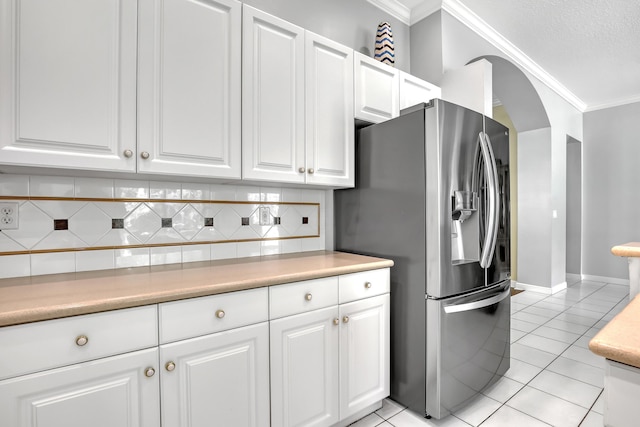1741 Annandale Cir, Royal Palm Beach, FL 33411 - kitchen with stainless steel fridge, ornamental molding, tasteful backsplash, white cabinets, and light countertops