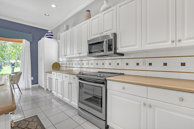 1741 Annandale Cir, Royal Palm Beach, FL 33411 - kitchen featuring appliances with stainless steel finishes, tasteful backsplash, light countertops, white cabinetry, and light tile patterned floors
