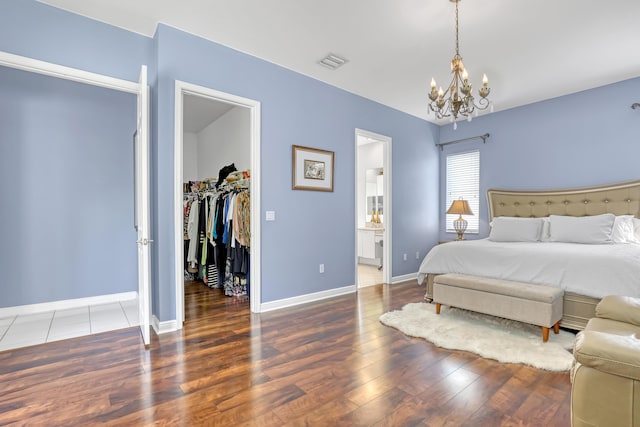 1741 Annandale Cir, Royal Palm Beach, FL 33411 - bedroom featuring a walk in closet, a chandelier, wood finished floors, and a closet