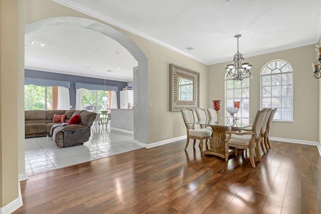 1741 Annandale Cir, Royal Palm Beach, FL 33411 - dining space with hardwood / wood-style floors, arched walkways, baseboards, ornamental molding, and a chandelier