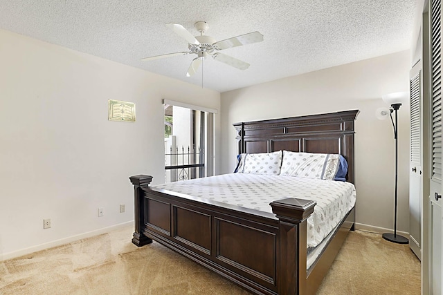 1017 Green Pine Blvd E, West Palm Beach, FL 33409 - bedroom featuring light carpet, baseboards, a textured ceiling, a ceiling fan, and a closet