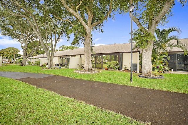 1017 Green Pine Blvd E, West Palm Beach, FL 33409 - view of front of home featuring a front yard and stucco siding