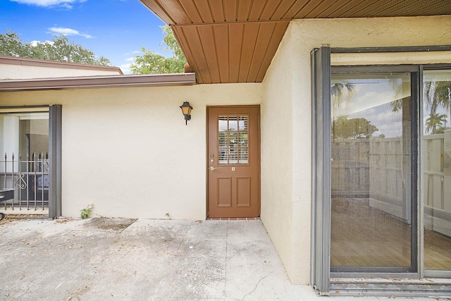 1017 Green Pine Blvd E, West Palm Beach, FL 33409 - doorway to property featuring stucco siding and a patio