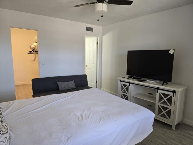 bedroom featuring wood finished floors, baseboards, and ceiling fan
