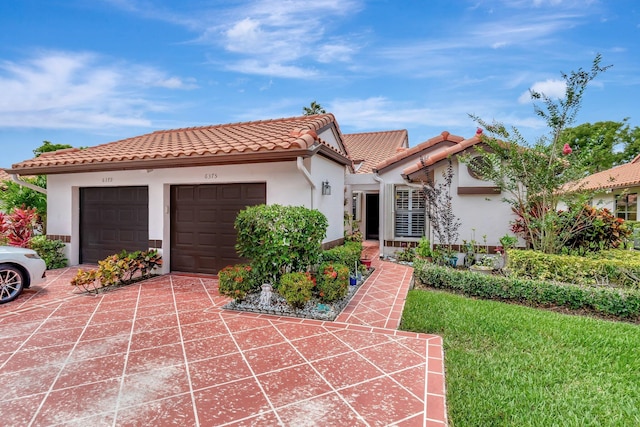 6375 Kings Gate Cir, Delray Beach, FL 33484 - mediterranean / spanish-style home with a tiled roof, stucco siding, driveway, and a garage