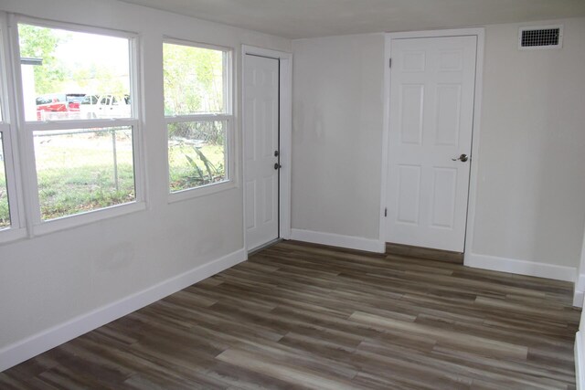 3264 Ocean Pkwy, Boynton Beach, FL 33435 - unfurnished room with baseboards, dark wood finished floors, and plenty of natural light