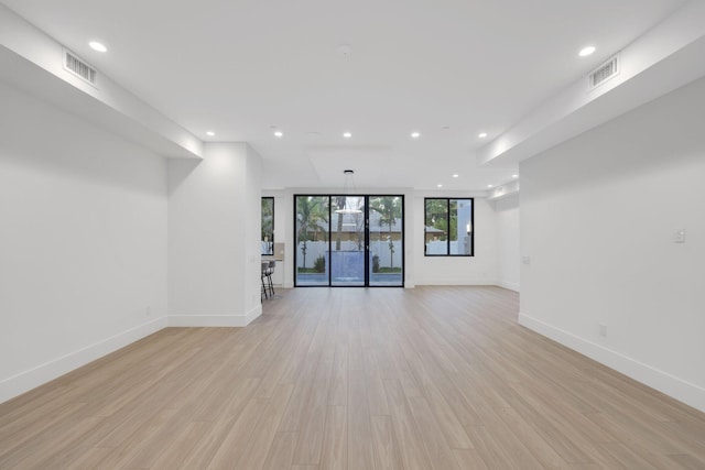 spare room with recessed lighting, baseboards, and light wood-style flooring