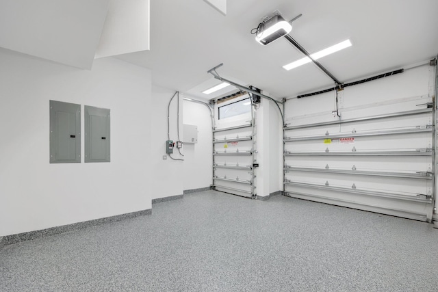 garage featuring electric panel and baseboards
