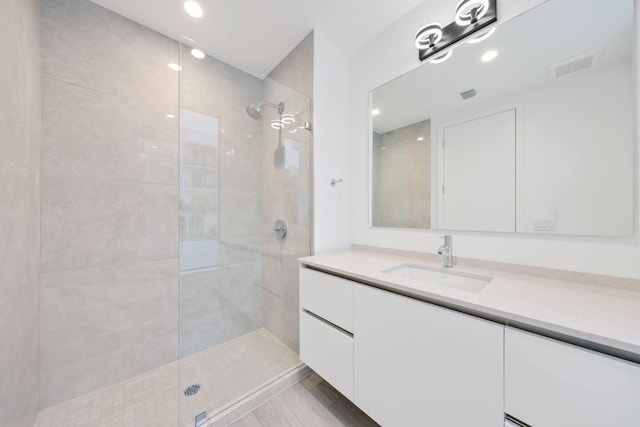 full bath with walk in shower, vanity, and recessed lighting