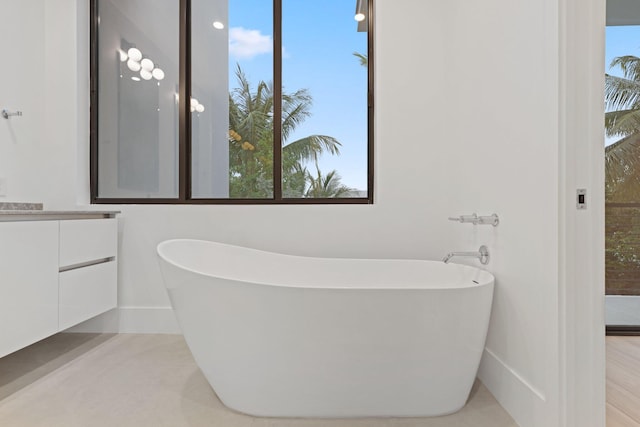 full bathroom with vanity and a soaking tub