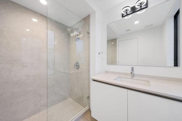 bathroom featuring walk in shower, vanity, and recessed lighting