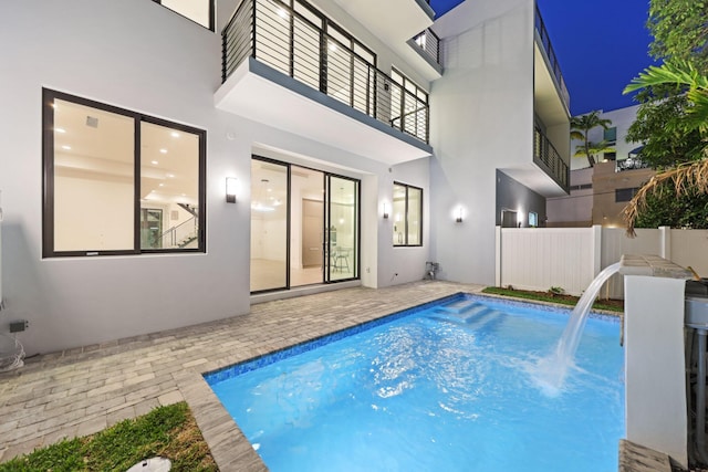 view of swimming pool featuring fence and a patio area