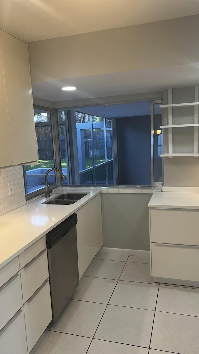 2710 SW 6th St SW, Boynton Beach, FL 33435 - kitchen with stainless steel dishwasher, a sink, and white cabinetry