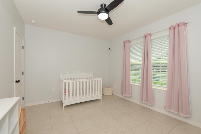 1222 SW Granadeer St, Port Saint Lucie, FL 34983 - bedroom featuring baseboards, ceiling fan, a nursery area, and light tile patterned floors