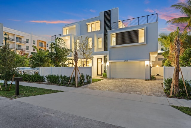 201 SE 4th Ave, Delray Beach, FL 33483 - contemporary home with an attached garage, stucco siding, and decorative driveway