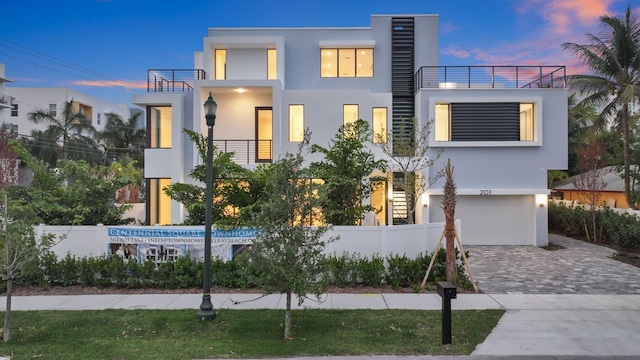 201 SE 4th Ave, Delray Beach, FL 33483 - modern home featuring stucco siding, a balcony, a garage, and driveway