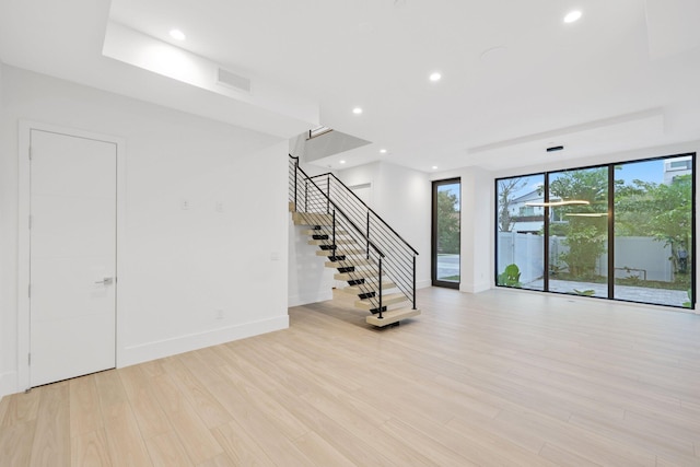 201 SE 4th Ave, Delray Beach, FL 33483 - spare room featuring stairway, baseboards, light wood finished floors, and recessed lighting