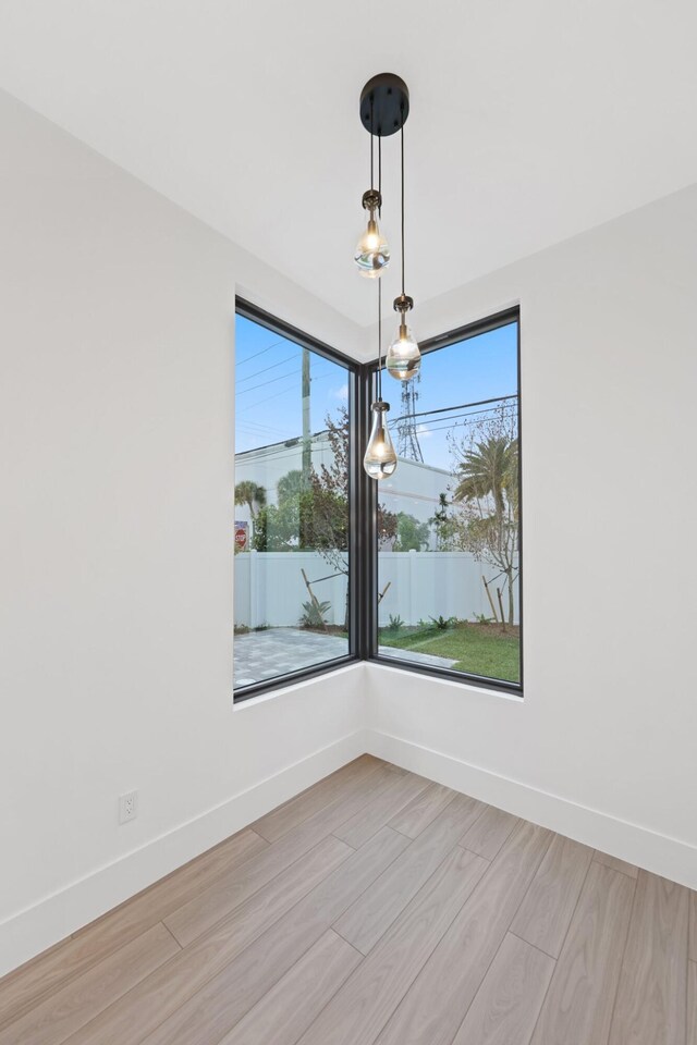 201 SE 4th Ave, Delray Beach, FL 33483 - spare room with healthy amount of natural light, light wood finished floors, and baseboards