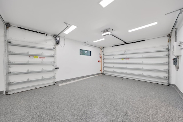 201 SE 4th Ave, Delray Beach, FL 33483 - garage featuring a garage door opener and baseboards