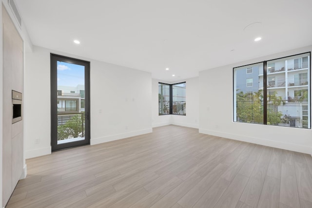 201 SE 4th Ave, Delray Beach, FL 33483 - empty room with light wood finished floors, baseboards, and recessed lighting