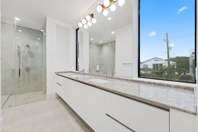 201 SE 4th Ave, Delray Beach, FL 33483 - bathroom with a shower stall, double vanity, tile patterned floors, and recessed lighting