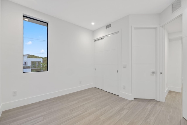 201 SE 4th Ave, Delray Beach, FL 33483 - unfurnished bedroom with light wood finished floors, baseboards, and recessed lighting