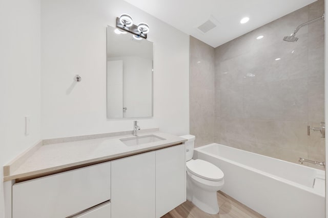 201 SE 4th Ave, Delray Beach, FL 33483 - bathroom featuring toilet, vanity, wood finished floors, and shower / tub combination