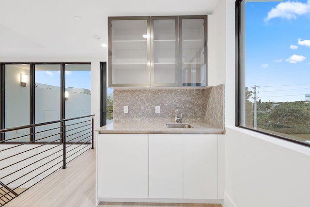 201 SE 4th Ave, Delray Beach, FL 33483 - indoor wet bar with tasteful backsplash, healthy amount of natural light, and light wood finished floors
