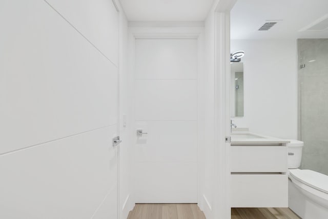 201 SE 4th Ave, Delray Beach, FL 33483 - bathroom with toilet, vanity, wood finished floors, and a shower