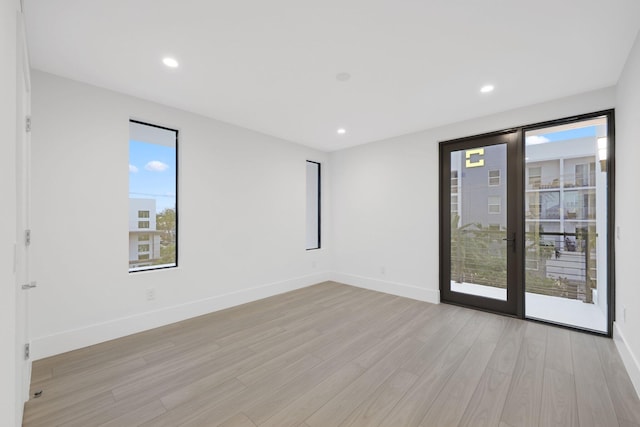 201 SE 4th Ave, Delray Beach, FL 33483 - empty room featuring light wood-style flooring, baseboards, and recessed lighting