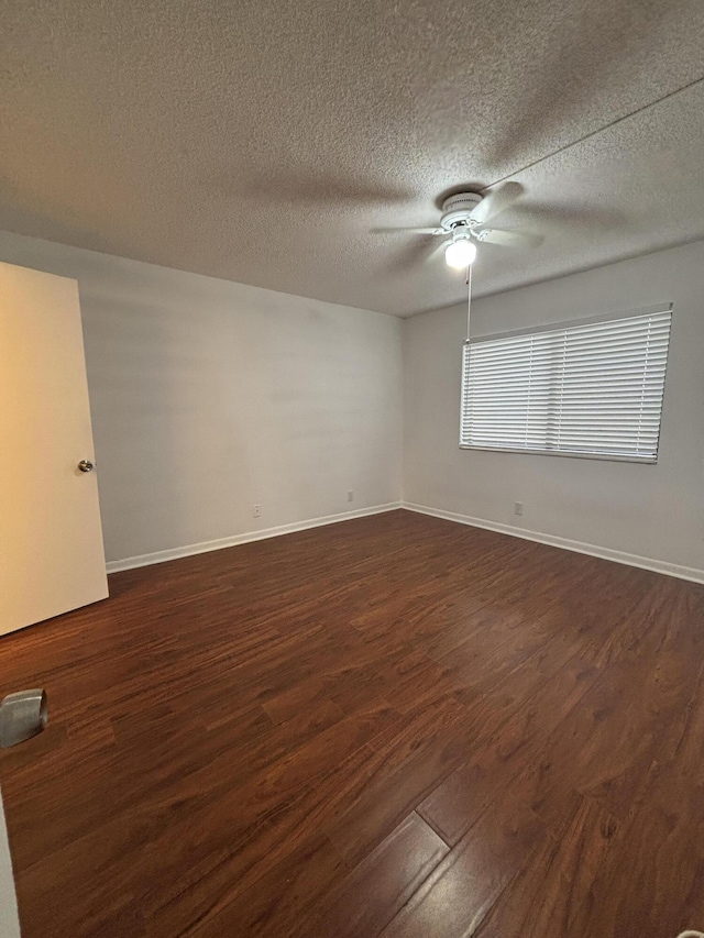 4820 Lucerne Lakes Blvd W Unit 107, Greenacres, FL 33467 - empty room featuring ceiling fan, dark wood finished floors, a textured ceiling, and baseboards