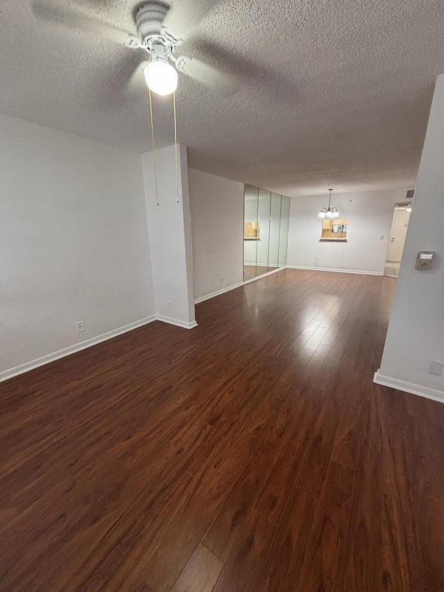4820 Lucerne Lakes Blvd W Unit 107, Greenacres, FL 33467 - unfurnished room with dark wood finished floors, a ceiling fan, a textured ceiling, and baseboards