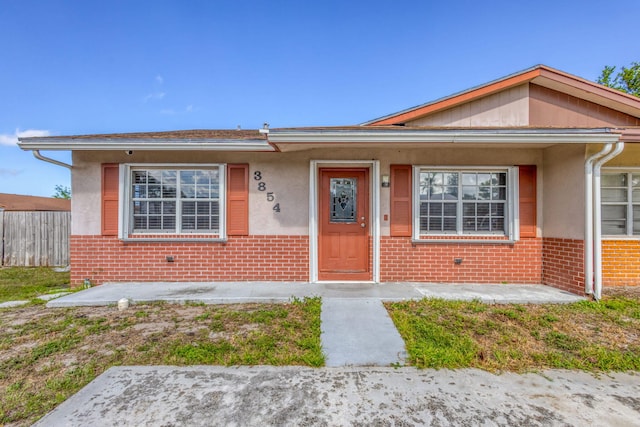 3854 Van Cott Cir, West Palm Beach, FL 33403 - bungalow-style home with brick siding, fence, and stucco siding