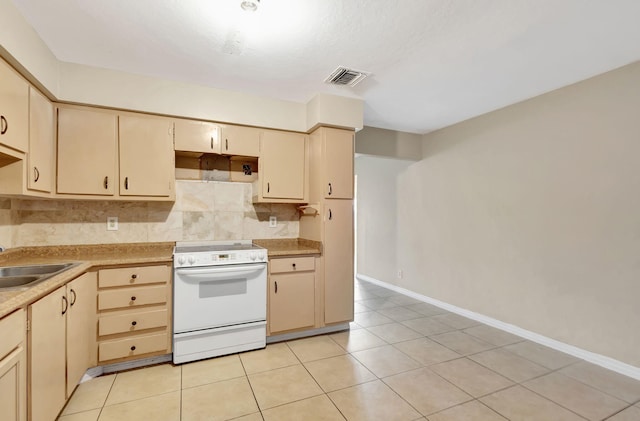 3854 Van Cott Cir, West Palm Beach, FL 33403 - kitchen featuring white range with electric cooktop, decorative backsplash, light countertops, light tile patterned flooring, and a sink