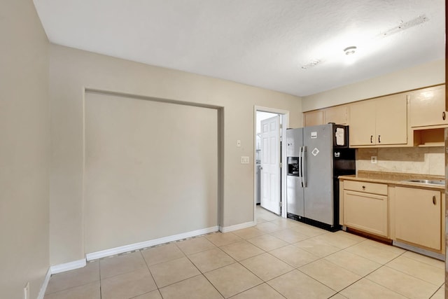 3854 Van Cott Cir, West Palm Beach, FL 33403 - kitchen with stainless steel fridge with ice dispenser, cream cabinetry, light countertops, and baseboards
