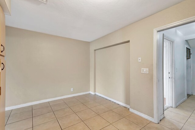 3854 Van Cott Cir, West Palm Beach, FL 33403 - unfurnished bedroom with light tile patterned flooring and baseboards