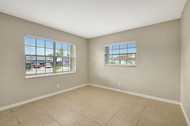 3854 Van Cott Cir, West Palm Beach, FL 33403 - unfurnished room featuring baseboards and light tile patterned flooring