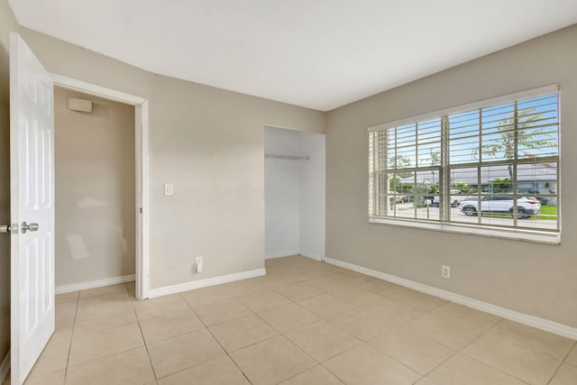 3854 Van Cott Cir, West Palm Beach, FL 33403 - unfurnished bedroom with baseboards, light tile patterned floors, and a closet