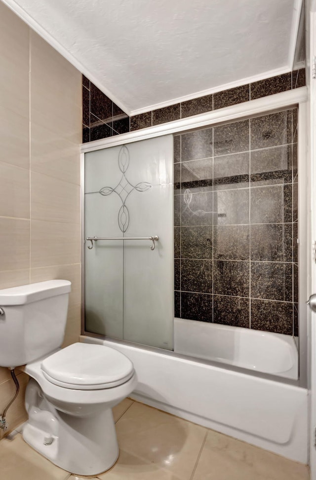 3854 Van Cott Cir, West Palm Beach, FL 33403 - full bathroom with tile patterned flooring, toilet, tile walls, and combined bath / shower with glass door