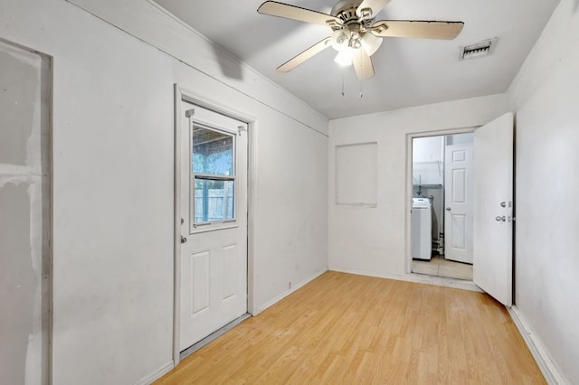 3854 Van Cott Cir, West Palm Beach, FL 33403 - spare room featuring washer / dryer, light wood finished floors, ceiling fan, and baseboards