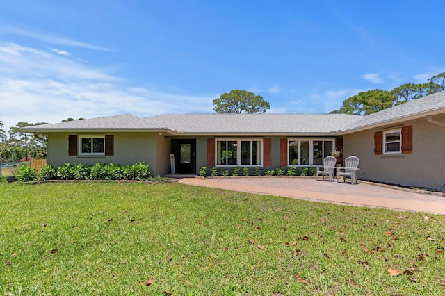 11447 Orange Grove Blvd, West Palm Beach, FL 33411 - rear view of house with a lawn, a patio area, and stucco siding