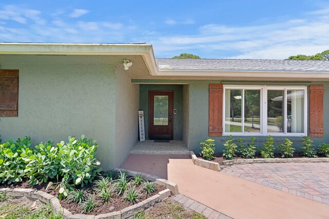 11447 Orange Grove Blvd, West Palm Beach, FL 33411 - view of exterior entry featuring stucco siding